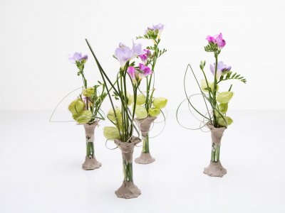 Clay vases with purple Freesias